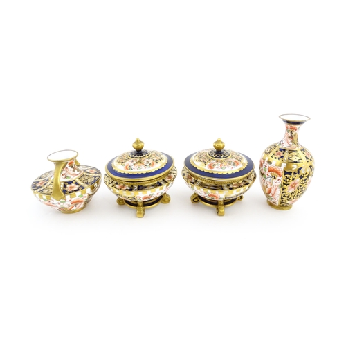 129 - Four items of Royal Crown Derby decorated in the Imari palette comprising a pair of lidded pots of u... 