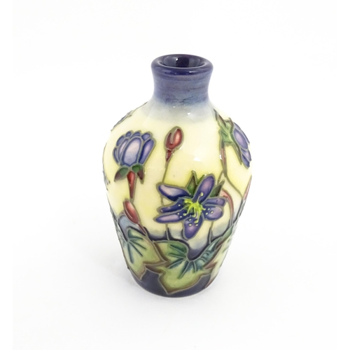 132 - A small Moorcroft vase decorated in the Hepatica pattern, designed by Emma Bossons. Marked under. Ap... 