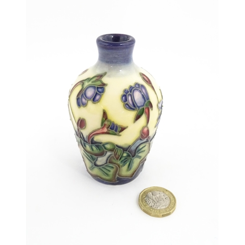 132 - A small Moorcroft vase decorated in the Hepatica pattern, designed by Emma Bossons. Marked under. Ap... 