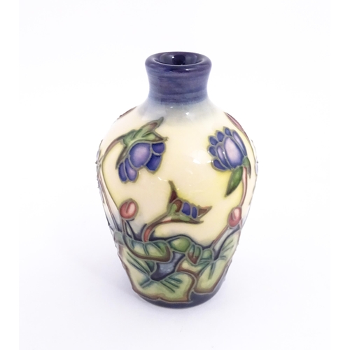 132 - A small Moorcroft vase decorated in the Hepatica pattern, designed by Emma Bossons. Marked under. Ap... 