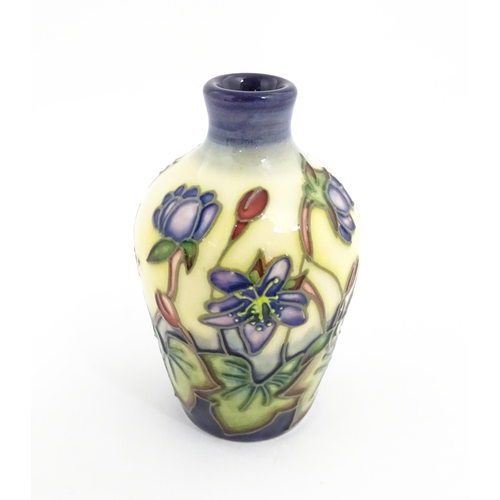 132 - A small Moorcroft vase decorated in the Hepatica pattern, designed by Emma Bossons. Marked under. Ap... 