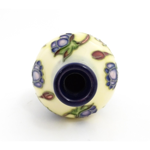 132 - A small Moorcroft vase decorated in the Hepatica pattern, designed by Emma Bossons. Marked under. Ap... 