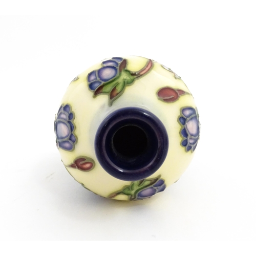 132 - A small Moorcroft vase decorated in the Hepatica pattern, designed by Emma Bossons. Marked under. Ap... 