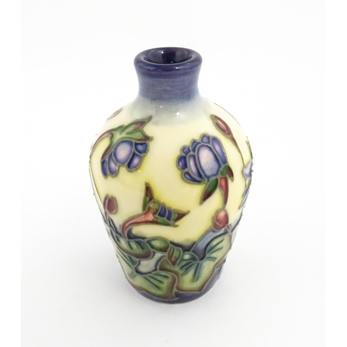 132 - A small Moorcroft vase decorated in the Hepatica pattern, designed by Emma Bossons. Marked under. Ap... 