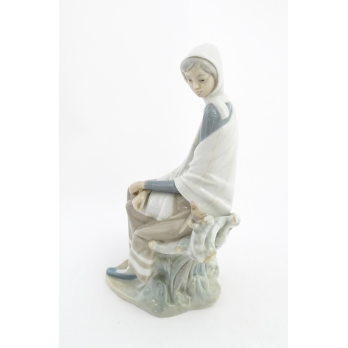 135 - A Lladro model New Shepherdess, depicting a woman watching a bird, model no. 4576. Marked under. App... 