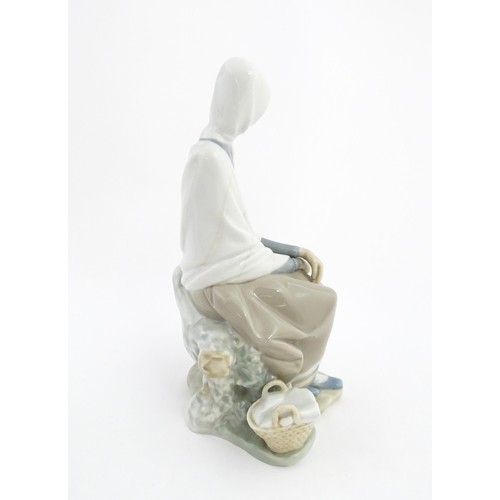 135 - A Lladro model New Shepherdess, depicting a woman watching a bird, model no. 4576. Marked under. App... 