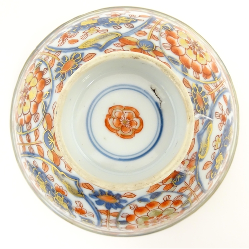 14 - A small Oriental dish decorated in the Imari palette, the centre with stylised fruit tree, the rever... 