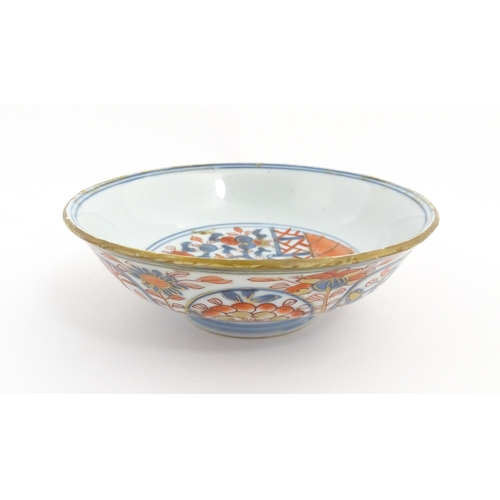 14 - A small Oriental dish decorated in the Imari palette, the centre with stylised fruit tree, the rever... 