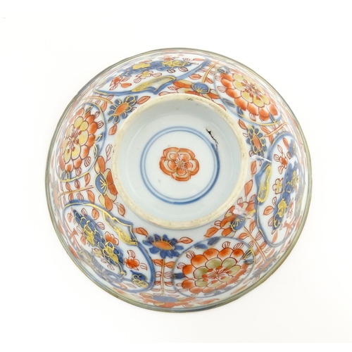 14 - A small Oriental dish decorated in the Imari palette, the centre with stylised fruit tree, the rever... 