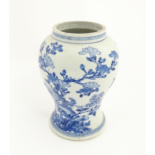 15 - A Chinese blue and white baluster vase decorated with flowers, foliage, butterflies and birds. Appro... 