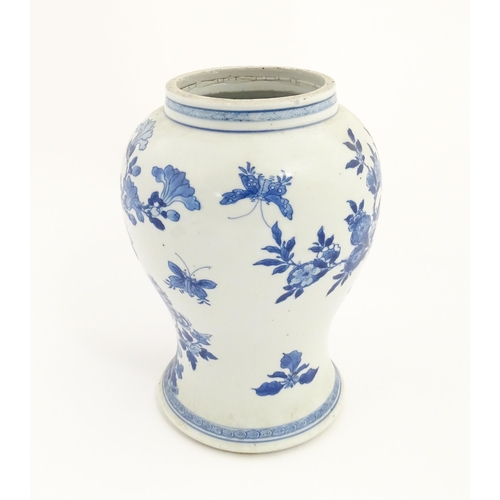 15 - A Chinese blue and white baluster vase decorated with flowers, foliage, butterflies and birds. Appro... 