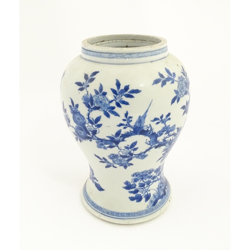 15 - A Chinese blue and white baluster vase decorated with flowers, foliage, butterflies and birds. Appro... 