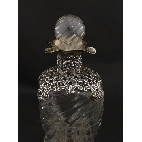 162 - A Victorian glass glug glug / pinch decanter with a pierced silver mount hallmarked London 1898, mak... 