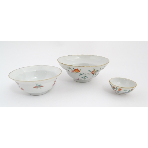 31 - Three Chinese bowls to include an example with a lobed edge decorated with a fruiting peach tree and... 