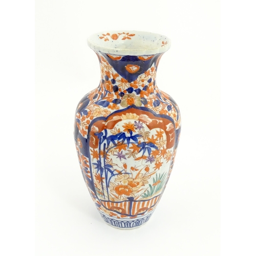 44 - A Japanese vase decorated in the Imari palette with flowers and foliage, with further floral motifs ... 