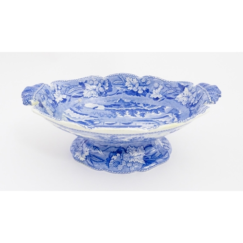 71 - A 19thC Minton blue and white tazza / pedestal dish decorated in the Italian Ruins pattern. Marked u... 