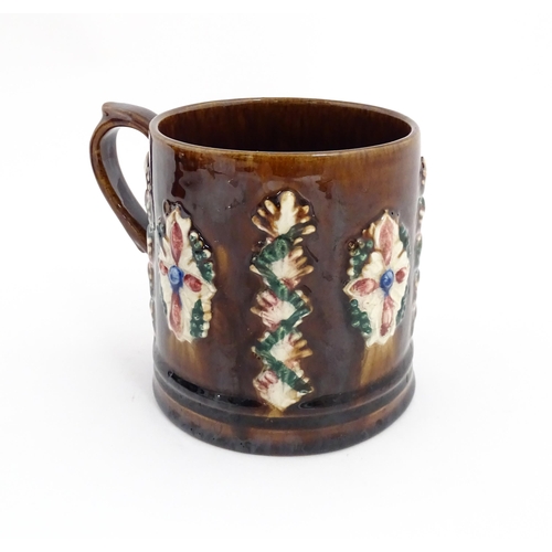 77 - A Victorian Measham mug with applied floral and foliate decoration and plaque inscribed Navigation I... 