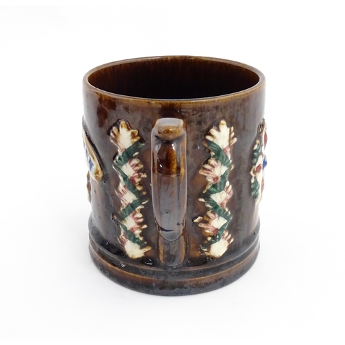 77 - A Victorian Measham mug with applied floral and foliate decoration and plaque inscribed Navigation I... 