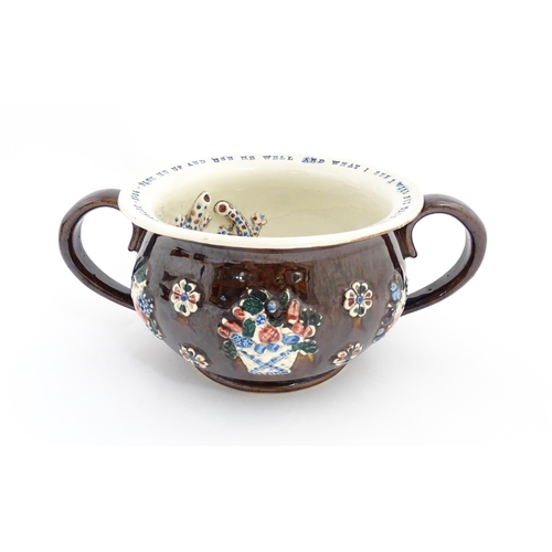 78 - A Victorian Measham bargeware twin handled chamber pot, the exterior with applied flower decoration,... 