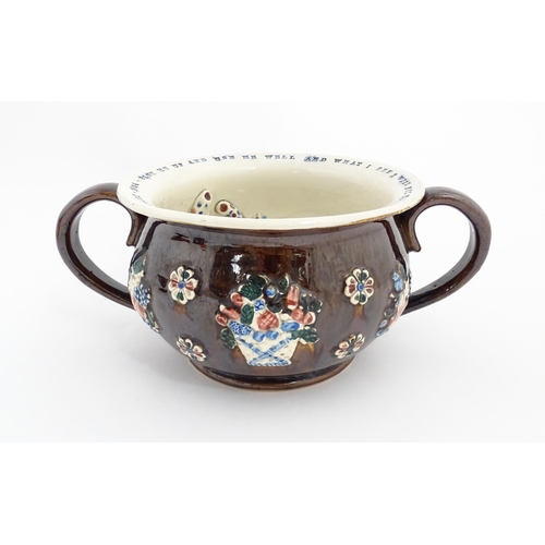 78 - A Victorian Measham bargeware twin handled chamber pot, the exterior with applied flower decoration,... 