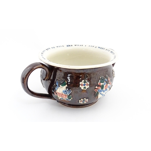 78 - A Victorian Measham bargeware twin handled chamber pot, the exterior with applied flower decoration,... 