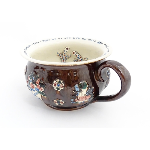 78 - A Victorian Measham bargeware twin handled chamber pot, the exterior with applied flower decoration,... 