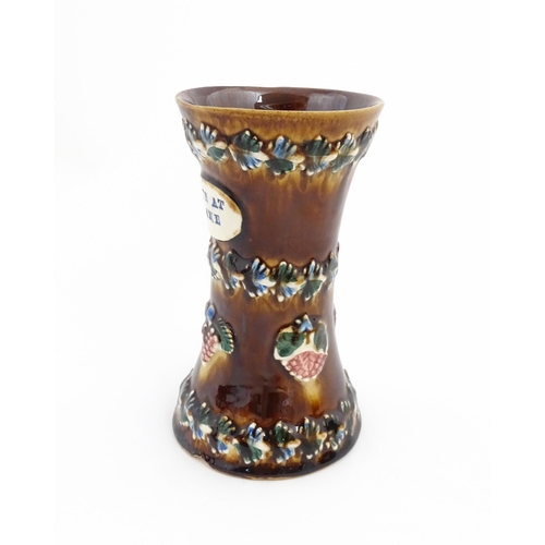 80 - A Victorian Measham bargeware vase with applied floral and foliate decoration and plaque inscribed L... 