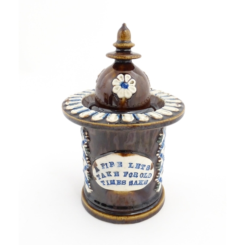 83 - A Victorian Measham bargeware tobacco jar and cover with applied foliate decoration and plaque inscr... 