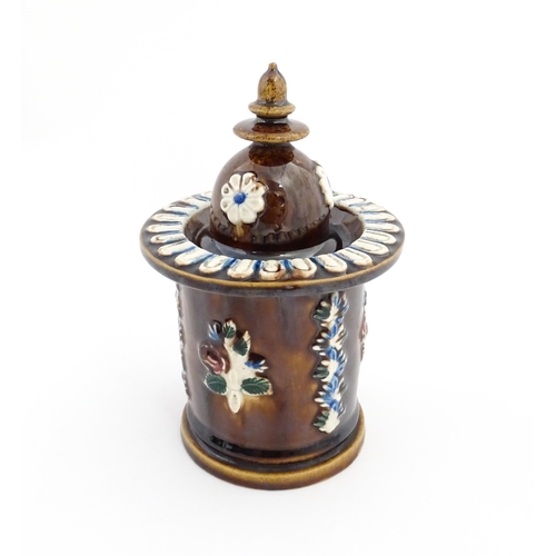 83 - A Victorian Measham bargeware tobacco jar and cover with applied foliate decoration and plaque inscr... 