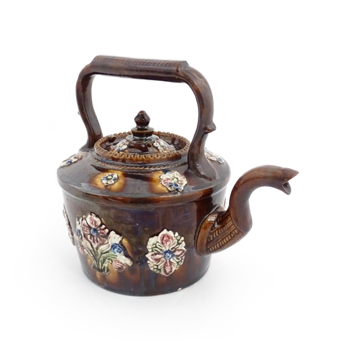 84 - A Victorian Measham bargeware teapot decorated with applied flower detail and plaque inscribed God B... 