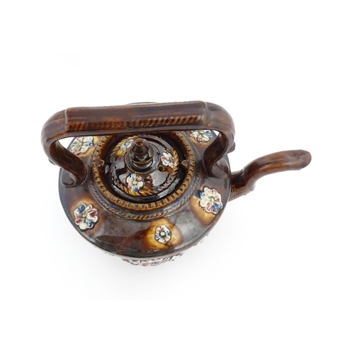 84 - A Victorian Measham bargeware teapot decorated with applied flower detail and plaque inscribed God B... 