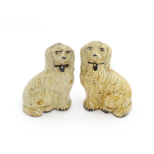 87 - A pair of Staffordshire pottery seated dogs with padlock detail to collars. Approx. 5 3/4