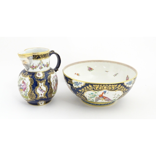 94 - A Worcester style jug and wash bowl with cobalt blue ground decorated with hand painted exotic birds... 