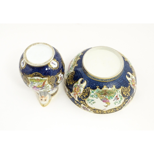 94 - A Worcester style jug and wash bowl with cobalt blue ground decorated with hand painted exotic birds... 