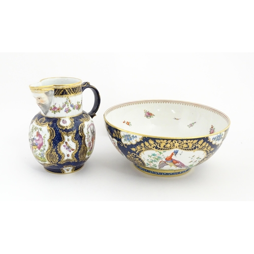 94 - A Worcester style jug and wash bowl with cobalt blue ground decorated with hand painted exotic birds... 