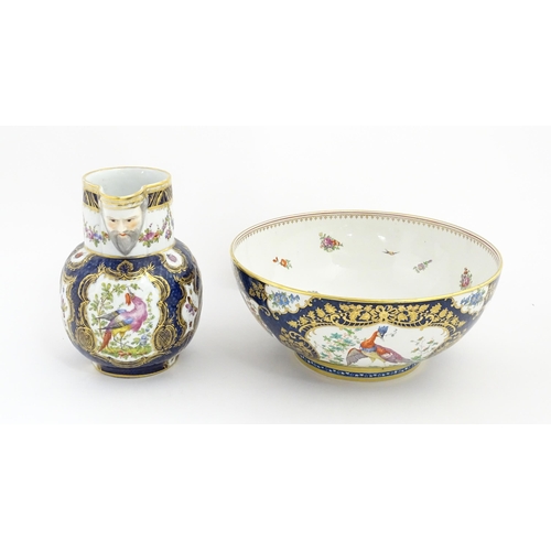 94 - A Worcester style jug and wash bowl with cobalt blue ground decorated with hand painted exotic birds... 