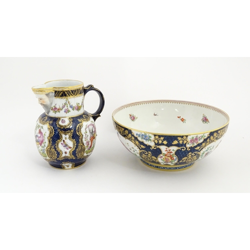 94 - A Worcester style jug and wash bowl with cobalt blue ground decorated with hand painted exotic birds... 