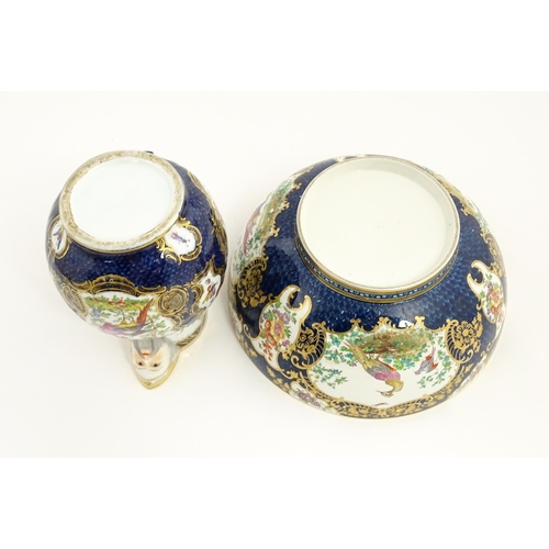 94 - A Worcester style jug and wash bowl with cobalt blue ground decorated with hand painted exotic birds... 