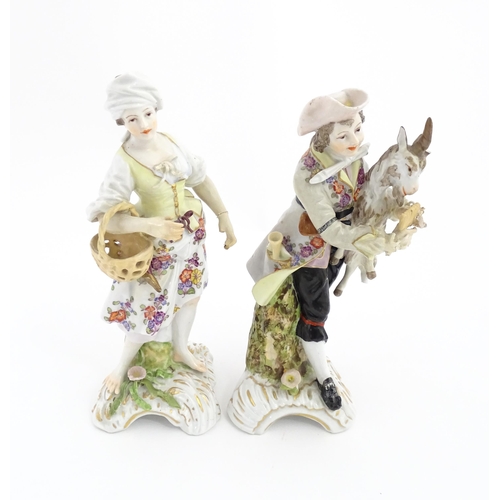 97 - Two Continental porcelain figures modelled as a travelling musician and companion, the male figure h... 