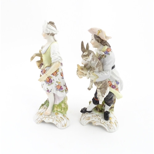 97 - Two Continental porcelain figures modelled as a travelling musician and companion, the male figure h... 