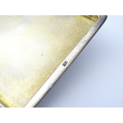 254 - A Continental .935 silver cigarette case with engine turned decoration and gilded interior. Approx. ... 