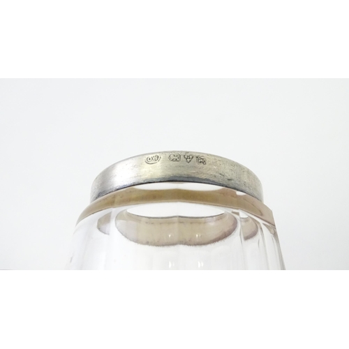 280 - A small glass mug with silver rim hallmarked Chester 1910, maker Richard Owen Williams. Approx 2 1/4... 