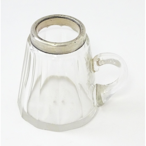 280 - A small glass mug with silver rim hallmarked Chester 1910, maker Richard Owen Williams. Approx 2 1/4... 