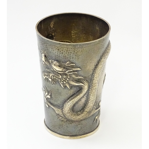 299 - A Chinese Export silver tankard decorated with an Imperial five claw dragon chasing the pearl of wis... 