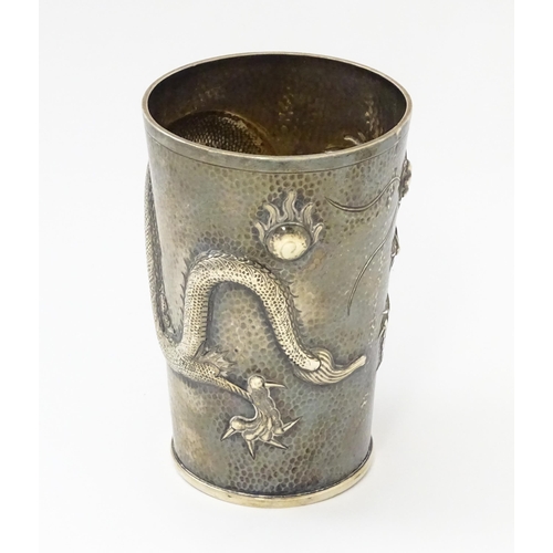 299 - A Chinese Export silver tankard decorated with an Imperial five claw dragon chasing the pearl of wis... 