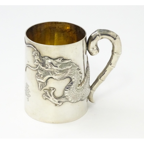 300 - A Chinese Export silver tankard /  mug with dragon detail and stylized bamboo handle . Marked under ... 