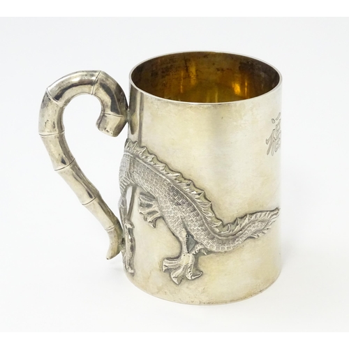 300 - A Chinese Export silver tankard /  mug with dragon detail and stylized bamboo handle . Marked under ... 