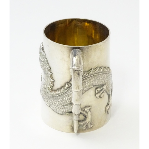 300 - A Chinese Export silver tankard /  mug with dragon detail and stylized bamboo handle . Marked under ... 