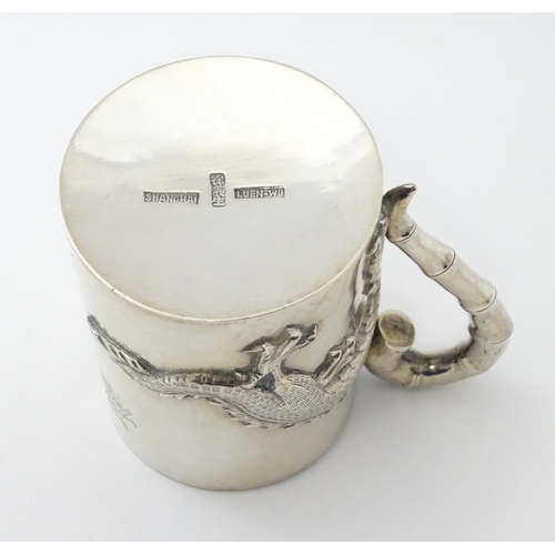 300 - A Chinese Export silver tankard /  mug with dragon detail and stylized bamboo handle . Marked under ... 