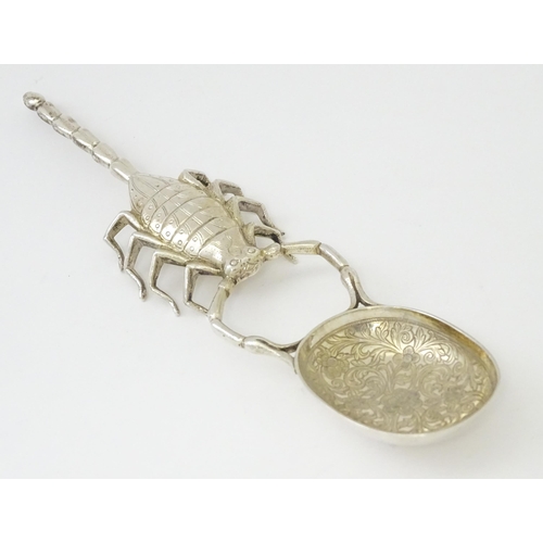 305 - A white metal spoon with Scorpion formed handle. Approx 7 3/4